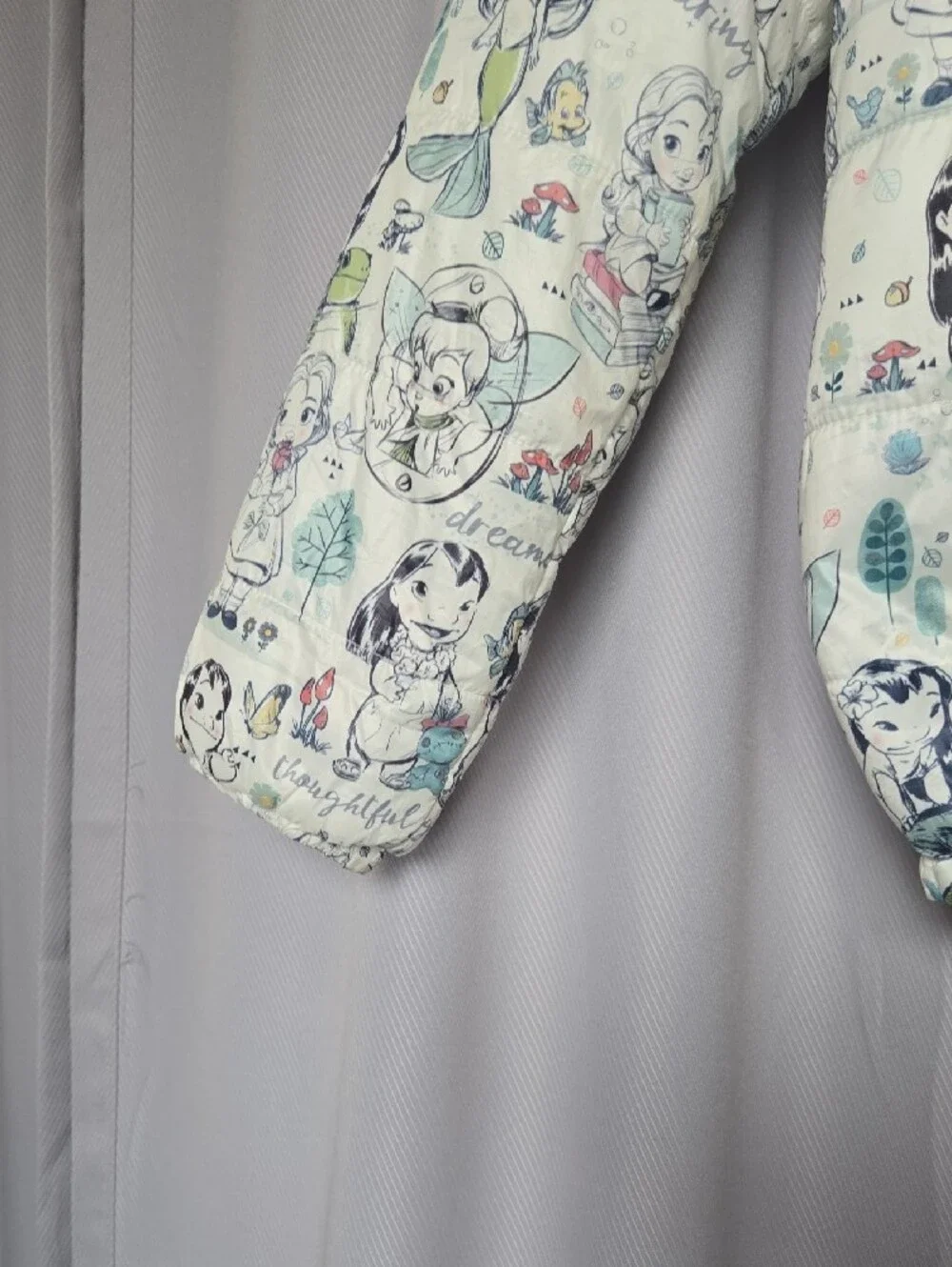 Disney Quilted Puffer Jacket with Cream Background and Pastel Accents